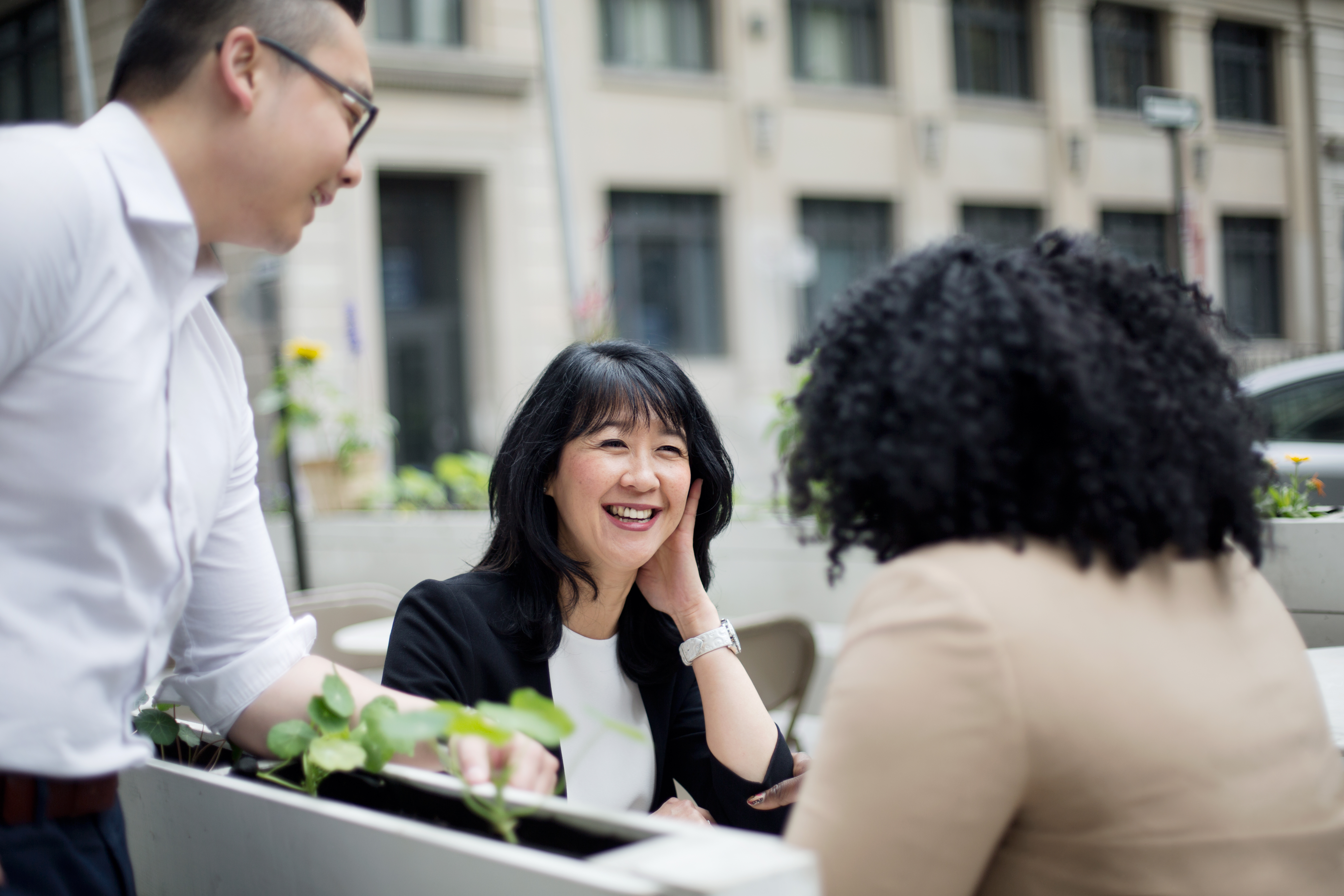 Team members at a table talking and laughing