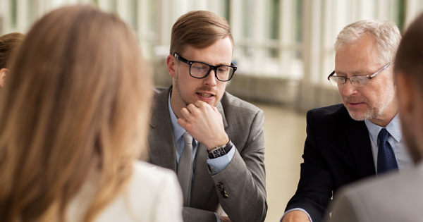 business people at the table discussing transition planning 