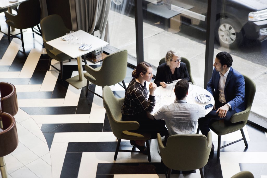 a family seated at a table with their financial advisor discussing family wealth 