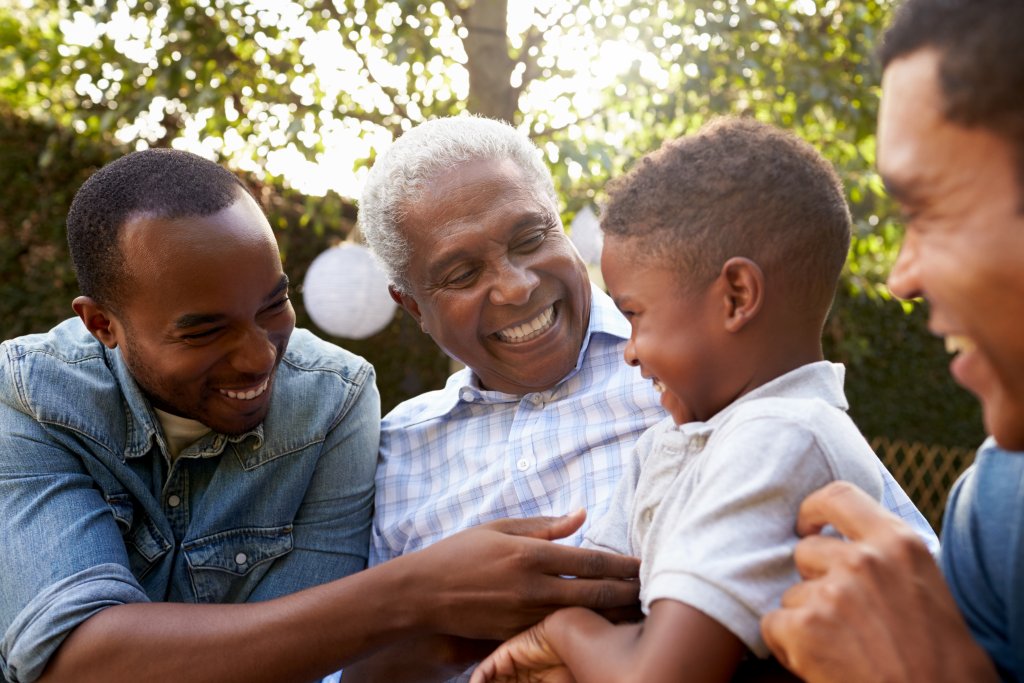 3 generations of family members laughing 