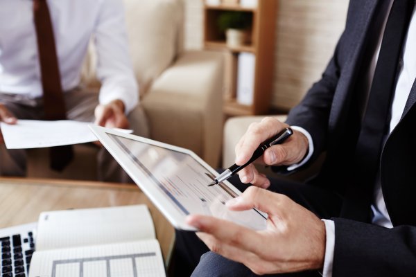 business person with a stylus on a tablet 