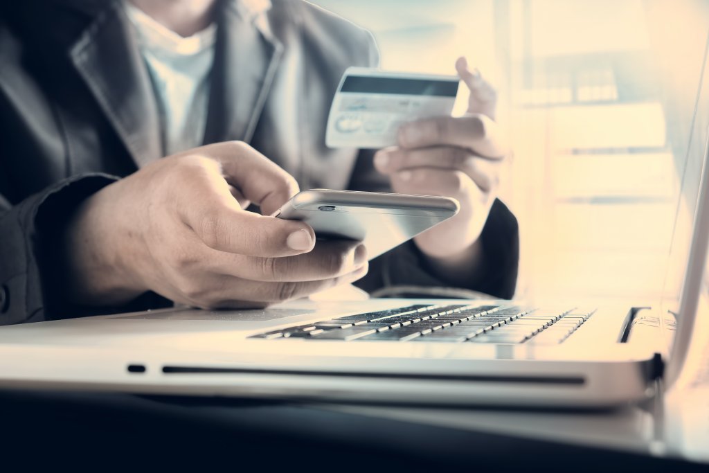 A person using their credit card to make an online purchase