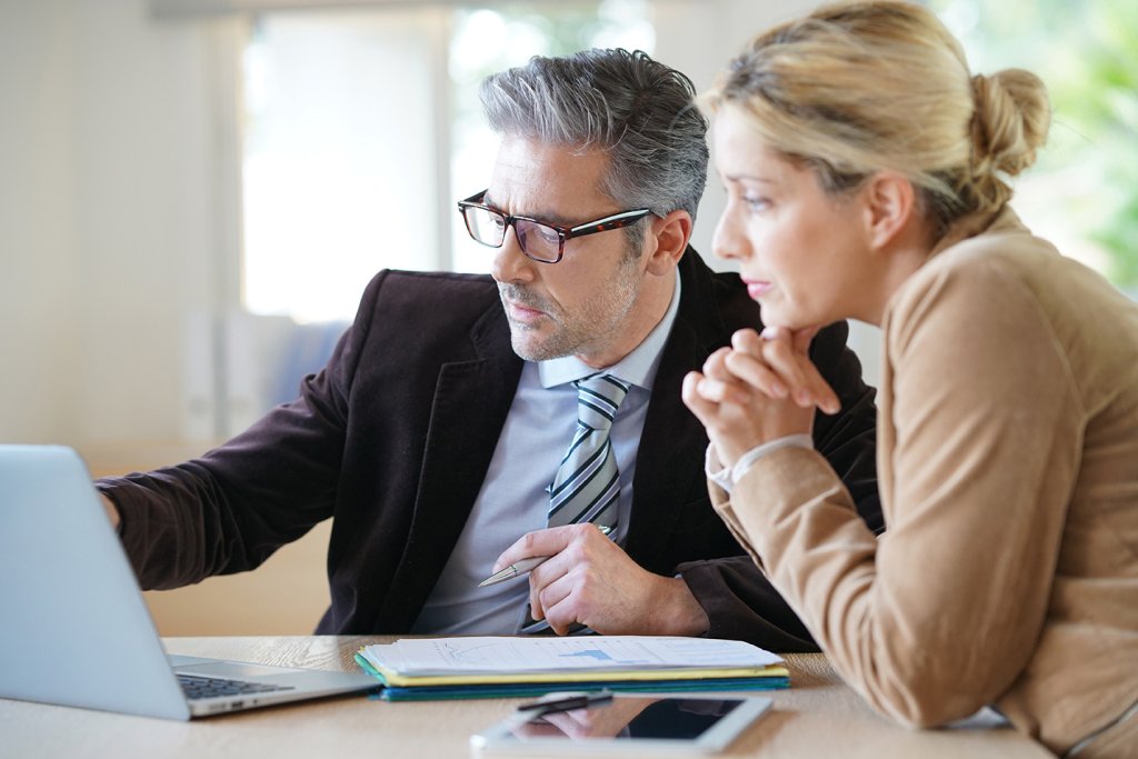 Two people looking at a computer screen